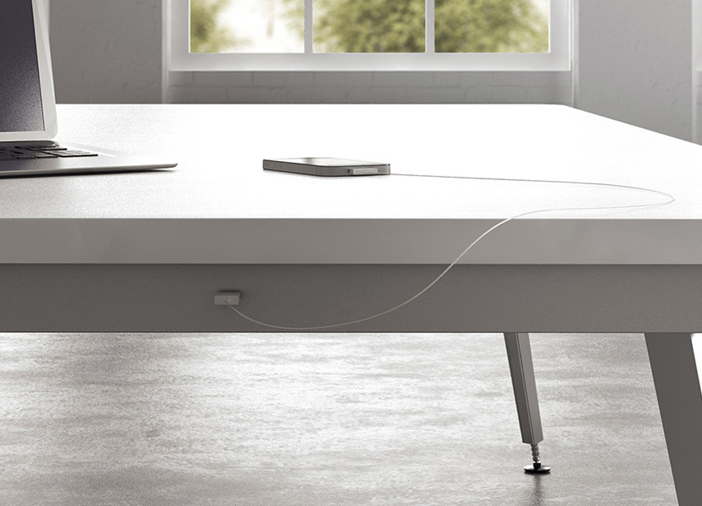 This boardroom furniture from OFS offers easy USB or 120V power access for every seat at the table without interrupting the minimal clean aesthetic of its environment.