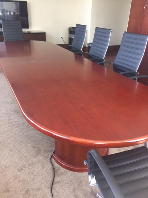 2nd Hand Office Furniture Tables - This 12' cherry wood oval conference table has two half-round bases.